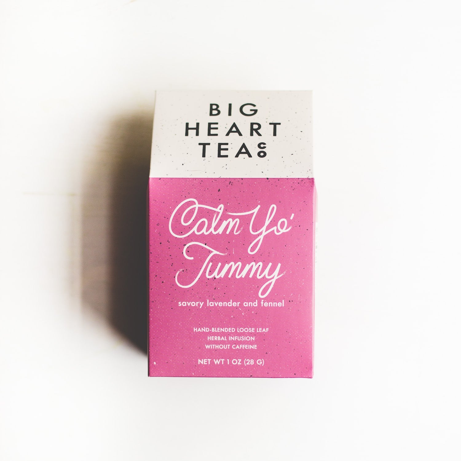 A pink box of Calm Yo' Tummy Tea, an organic blend featuring tulsi, lavender, fennel seed, and brahmi. Designed to stimulate digestion, soothe upset stomachs, relieve stress, and support lactation. Offers a balanced sweet and savory flavor profile.