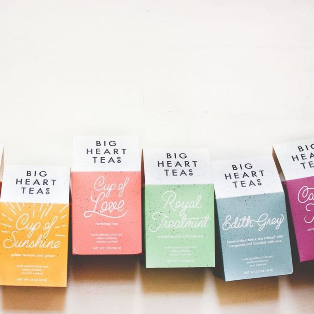 A variety of color tea box packages from Big Heart Tea Co. on a neutral background.