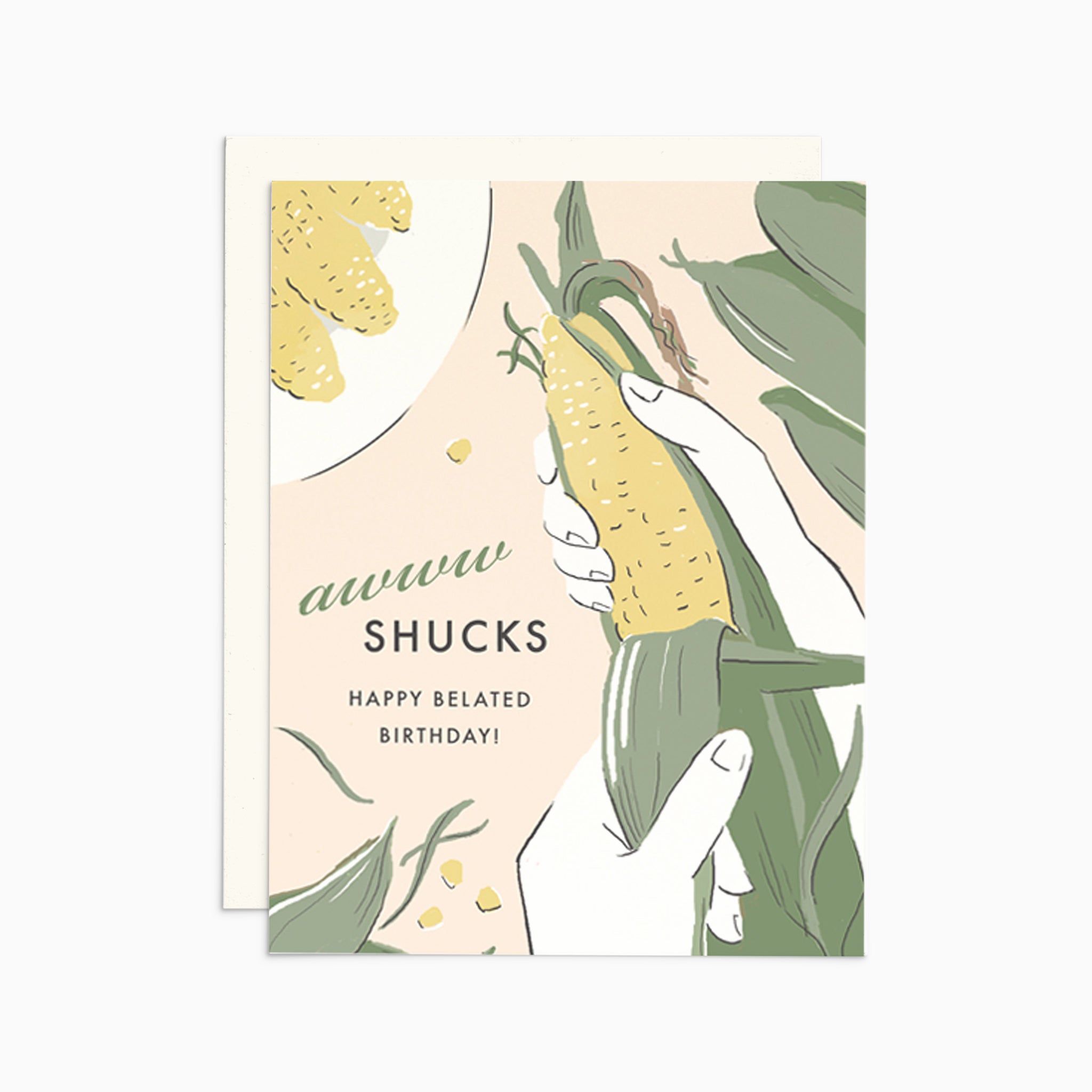A charming illustrated belated birthday card on premium warm white cardstock, featuring a punny text that reads 'awww shucks, happy belated birthday' alongside a whimsical corn cob being shucked.
