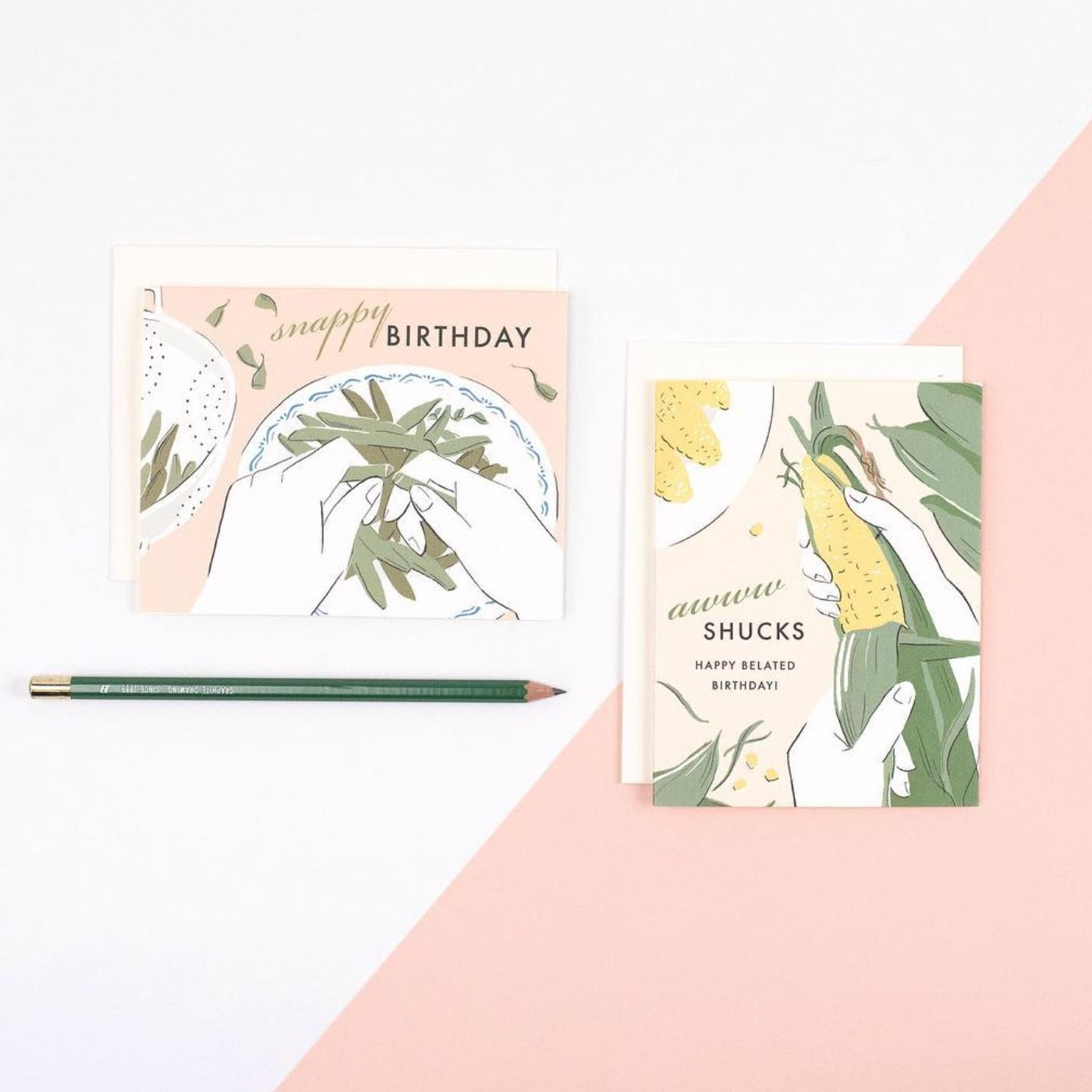 A charming illustrated belated birthday card on premium warm white cardstock, featuring a punny text that reads 'awww shucks, happy belated birthday' alongside a whimsical corn cob being shucked.