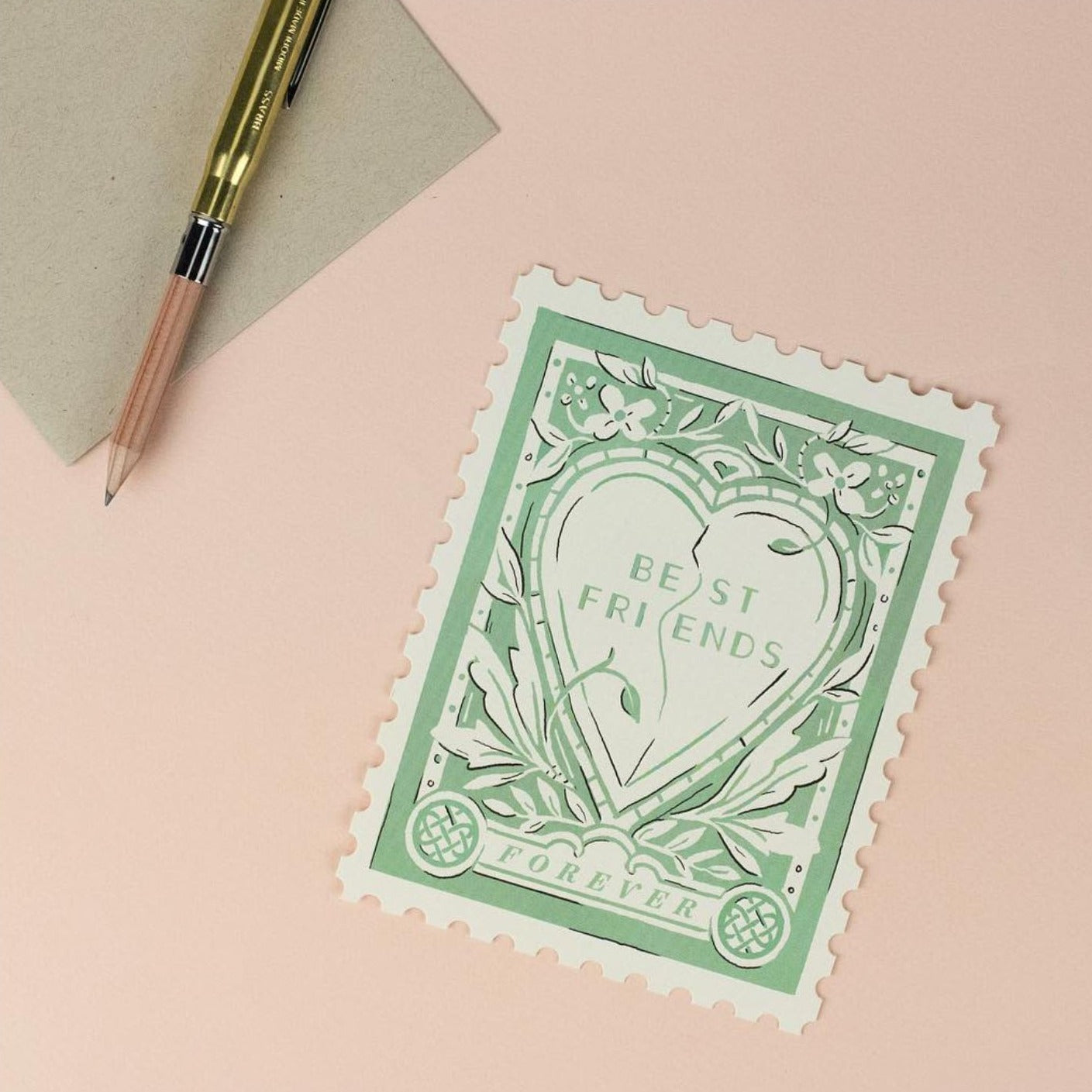 Illustrated 'Best Friends Forever' card on premium warm white cardstock, featuring a heart framed by elegant flourishes in soft tones of cream and green.