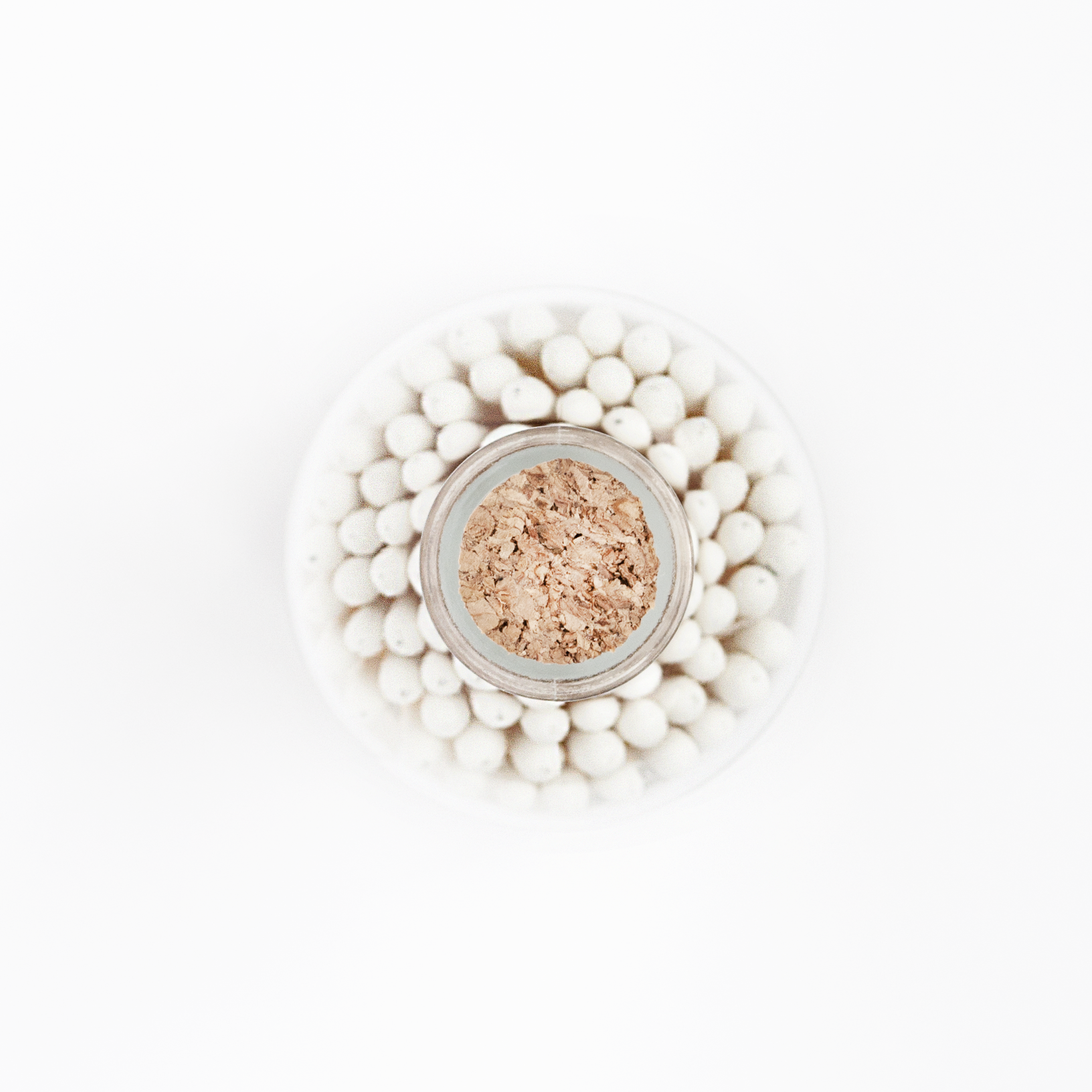 Top view of classic white-tipped matches in a corked apothecary jar by Frankie & Claude