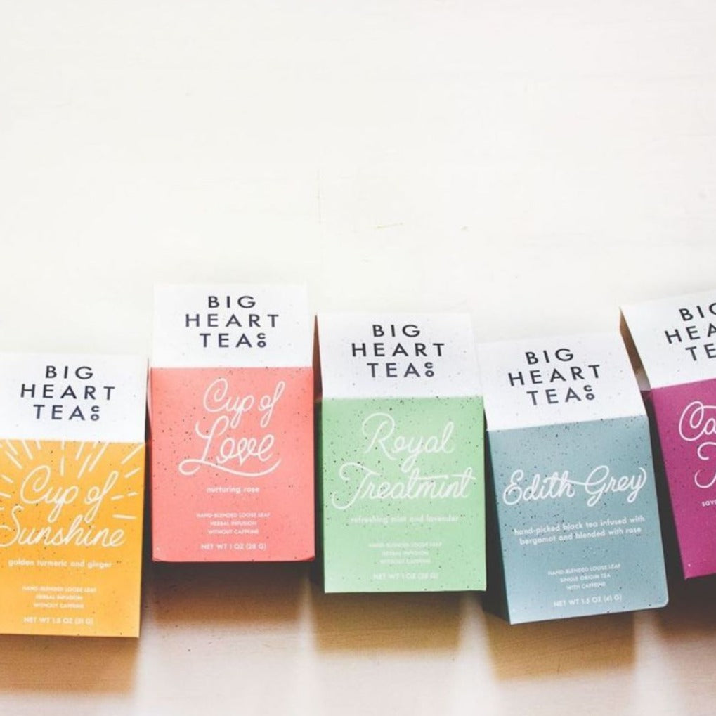 A variety of color tea box packages from Big Heart Tea Co. on a neutral background.