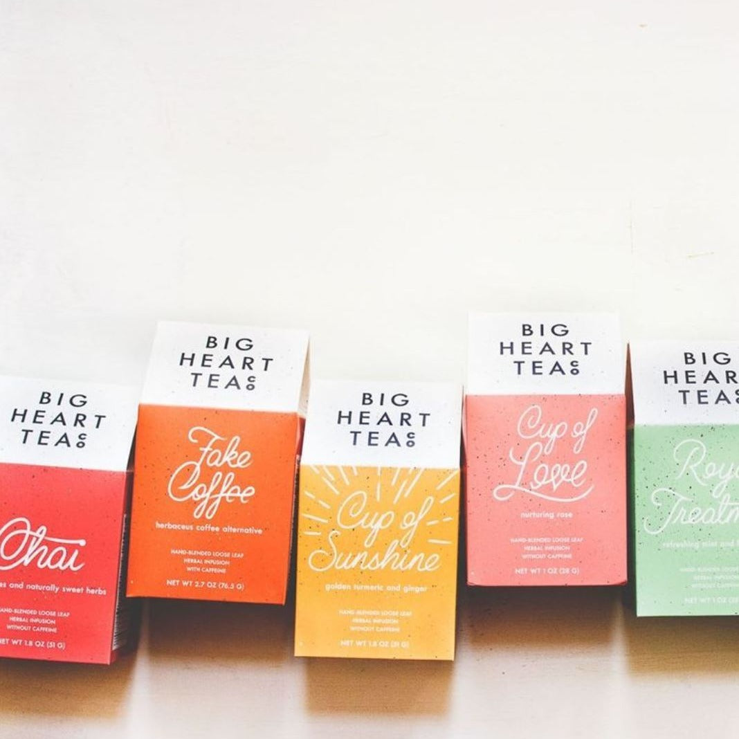 A variety of color tea box packages from Big Heart Tea Co. on a neutral background.