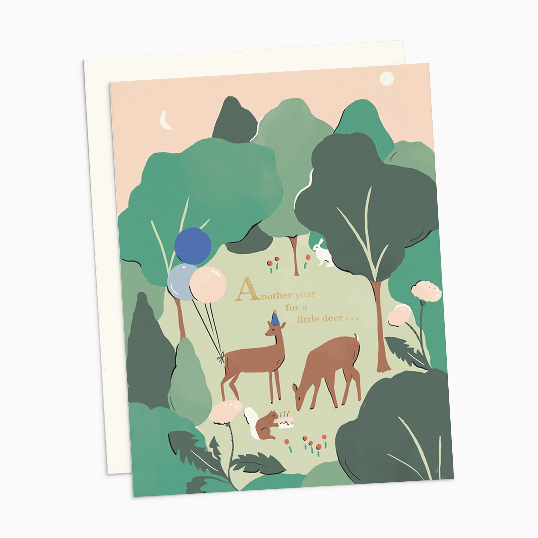 Illustrated birthday card with metallic gold foil text saying 'Another Year Older, My Little Deer,' featuring two deer in birthday hats with balloons on warm white cover cardstock.