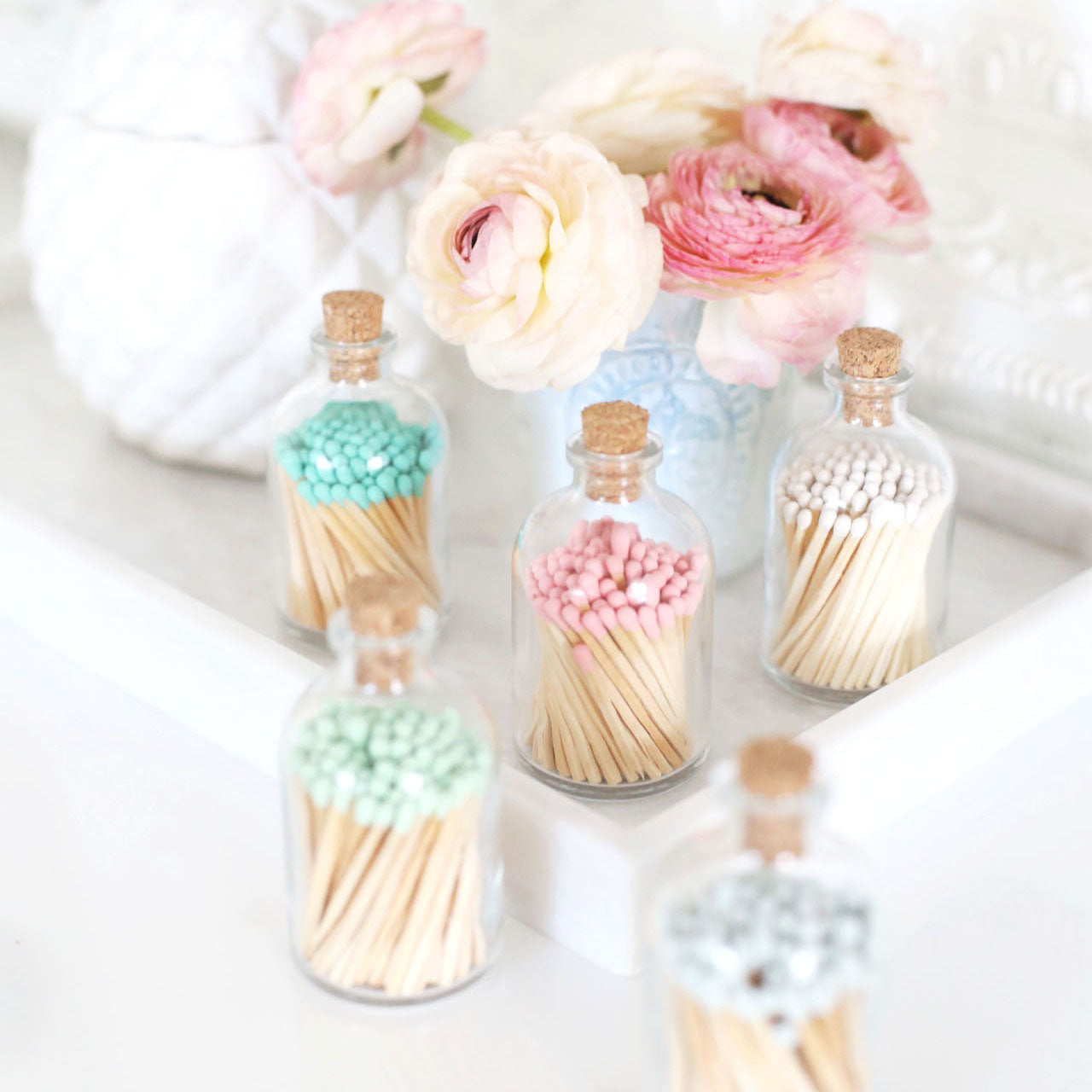 Collection of colorful match jars by Frankie & Claude, showcasing different vibrant shades for stylish candle lighting.