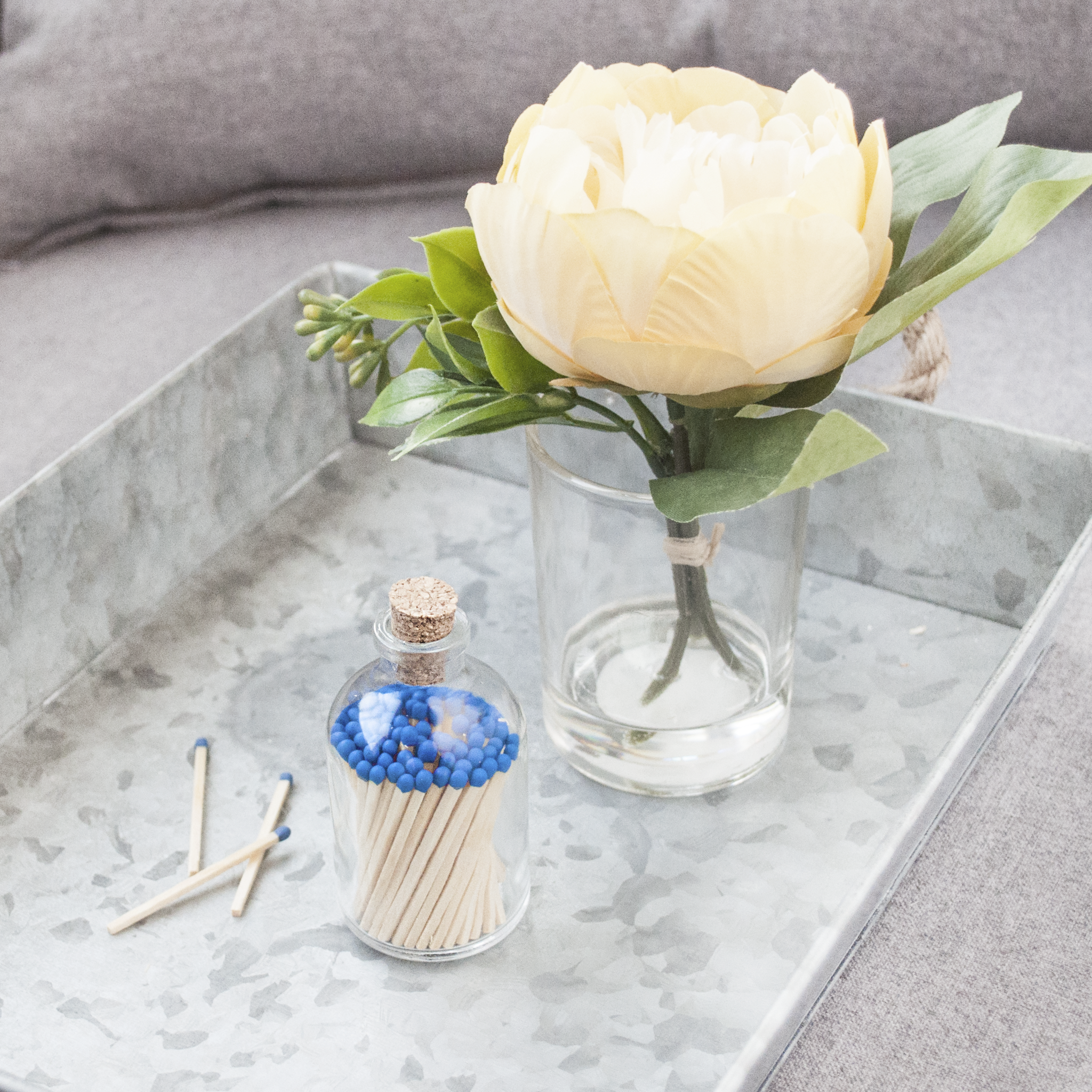 Royal Blue Match Jar by Frankie & Claude on a decorative tray with a floral arrangement.