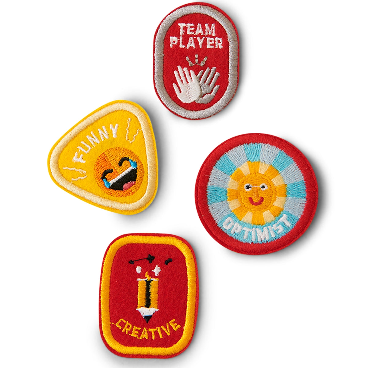Set of 4 Character Badge Patches designed for children, featuring the words 'Creative, Funny, Team Player, Optimist' with vibrant colors, adhesive and iron-on backing, displayed on a white background.