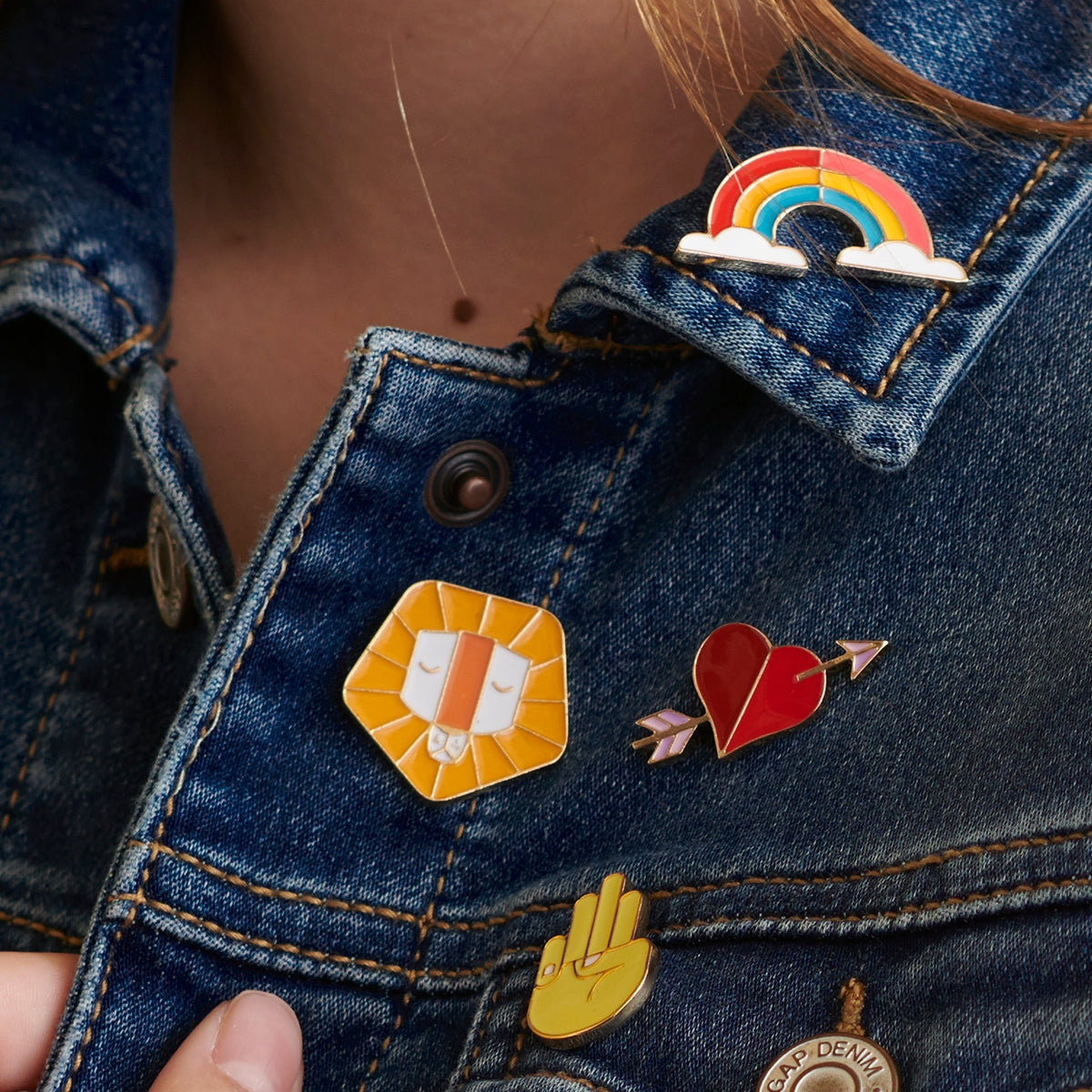 Set of 4 children's character badge enamel pins featuring the traits Curious, Honest, Perseverance, and Brave, perfect for personalizing kids' jackets, bags, or hats, shown on a denim jacket.